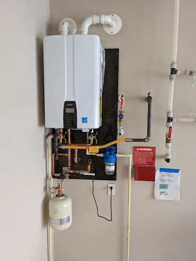 Professional plumber installing copper piping in a Cresco home